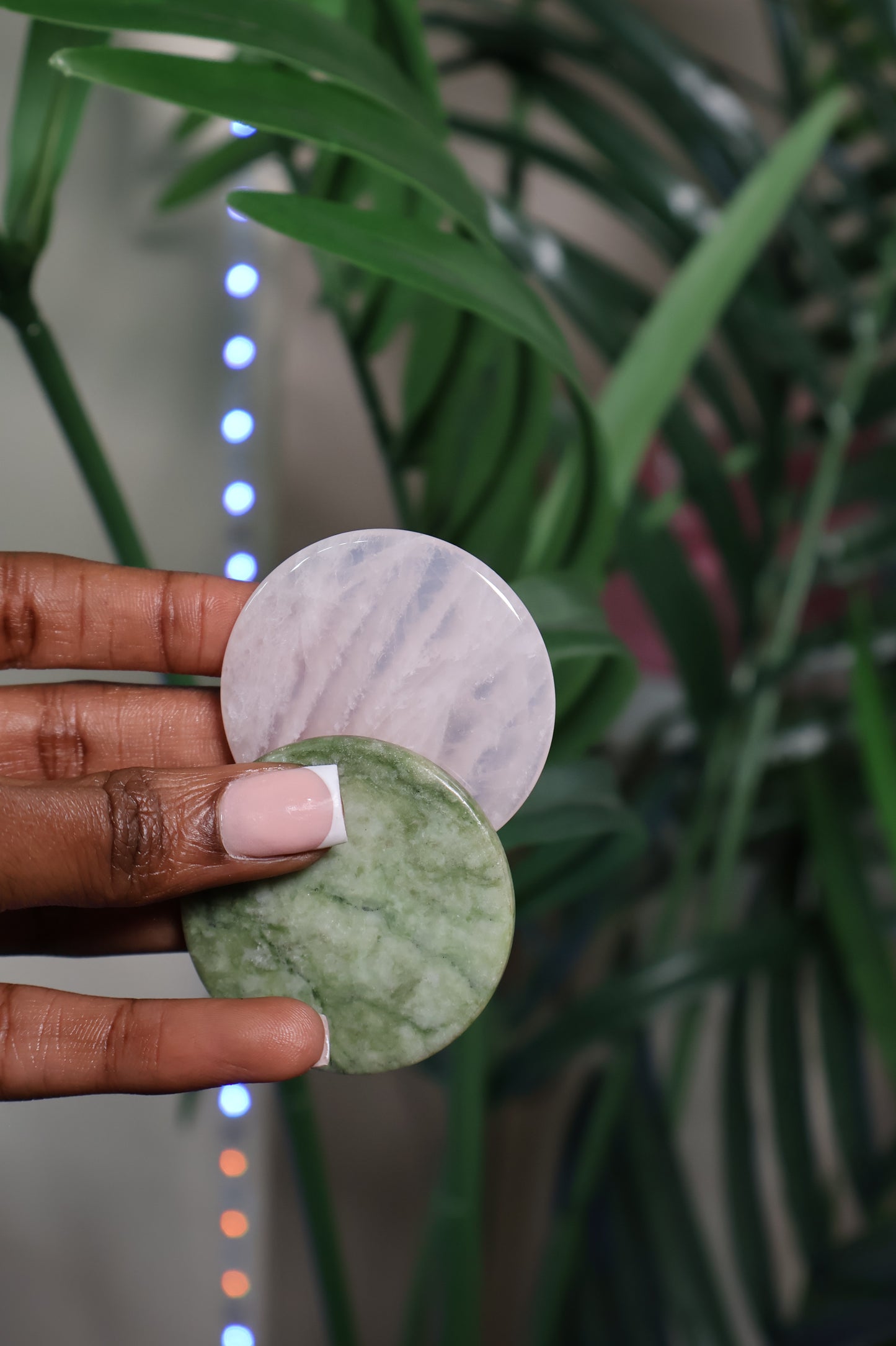 Jade Stone tools held in hand, essential for precise lash glue application, keeping adhesive at optimal temperature.